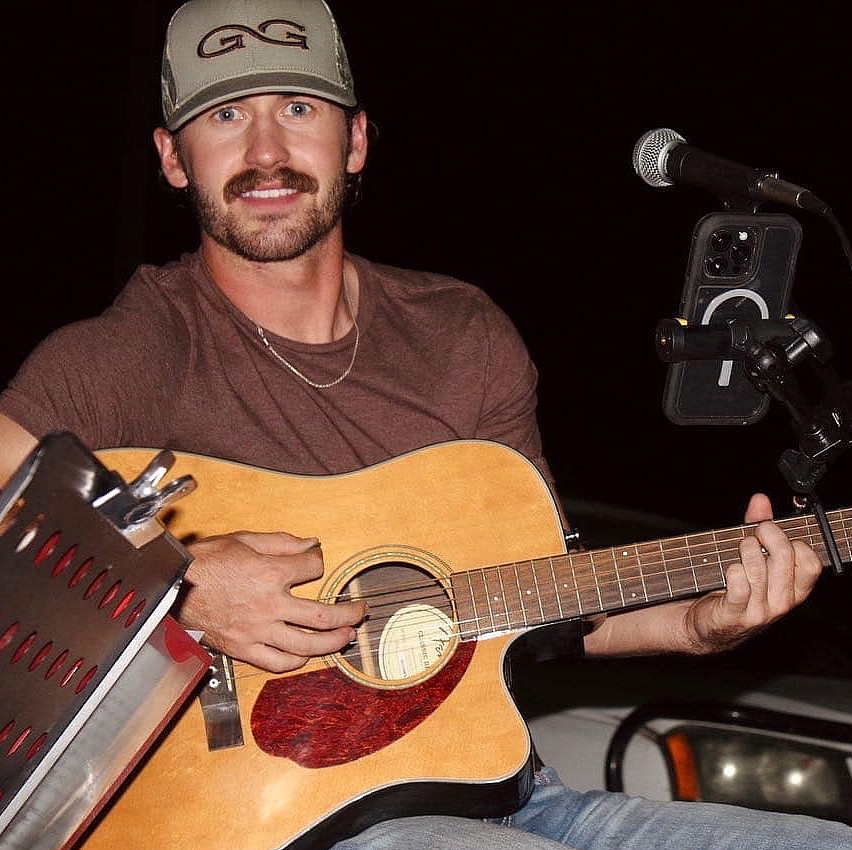 Portrait of Kyler Dean, holding guitar