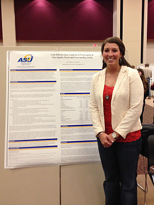 Darcy Weishuhn - research Darcy Weishuhn standing next to her research poster