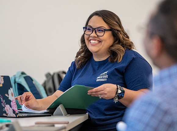Felicia Garcia flipping through her binder