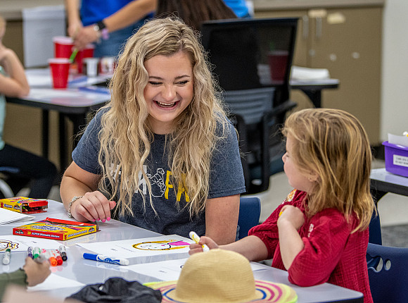 Reilly Amsler working with elementary school students