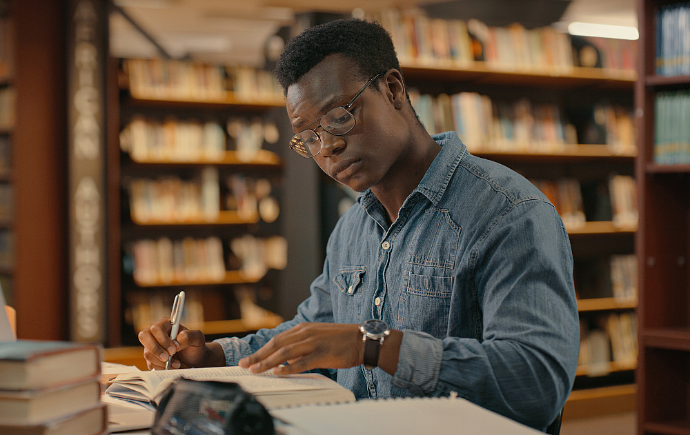 English 1401178950 A student studying in the library
