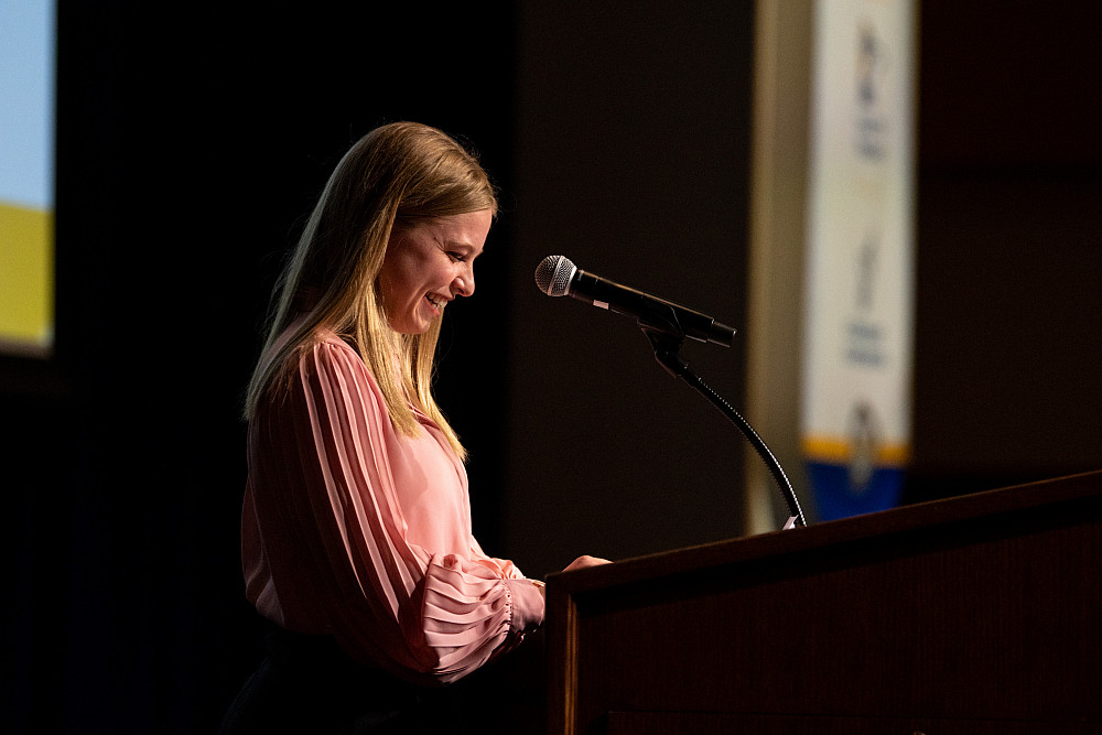 ASU student, Tressa Reading, speaking at a podium during a scholarship dinner