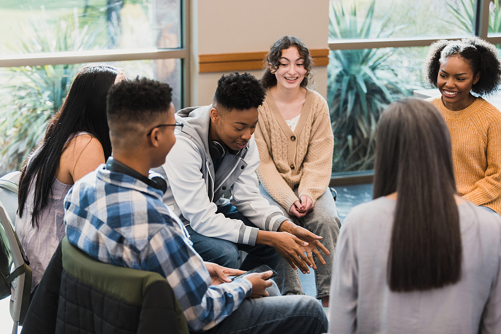 Psychology 1383890727 A group of students talking in a circle