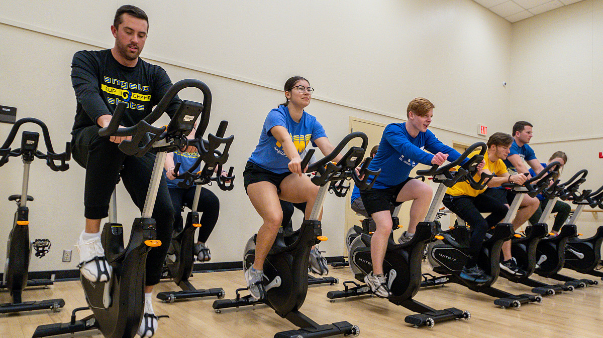 Angelo State students using ellipticals during a fitness class.