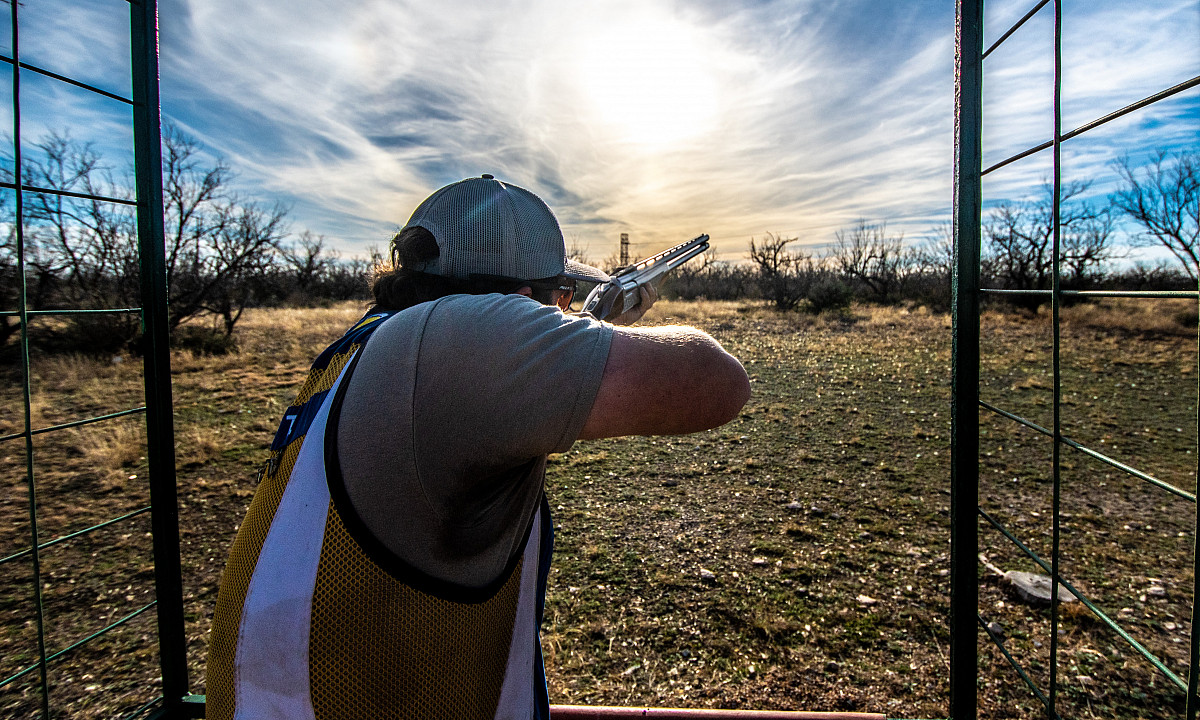 A student on the Shotgun Sports Team taking aim at a target