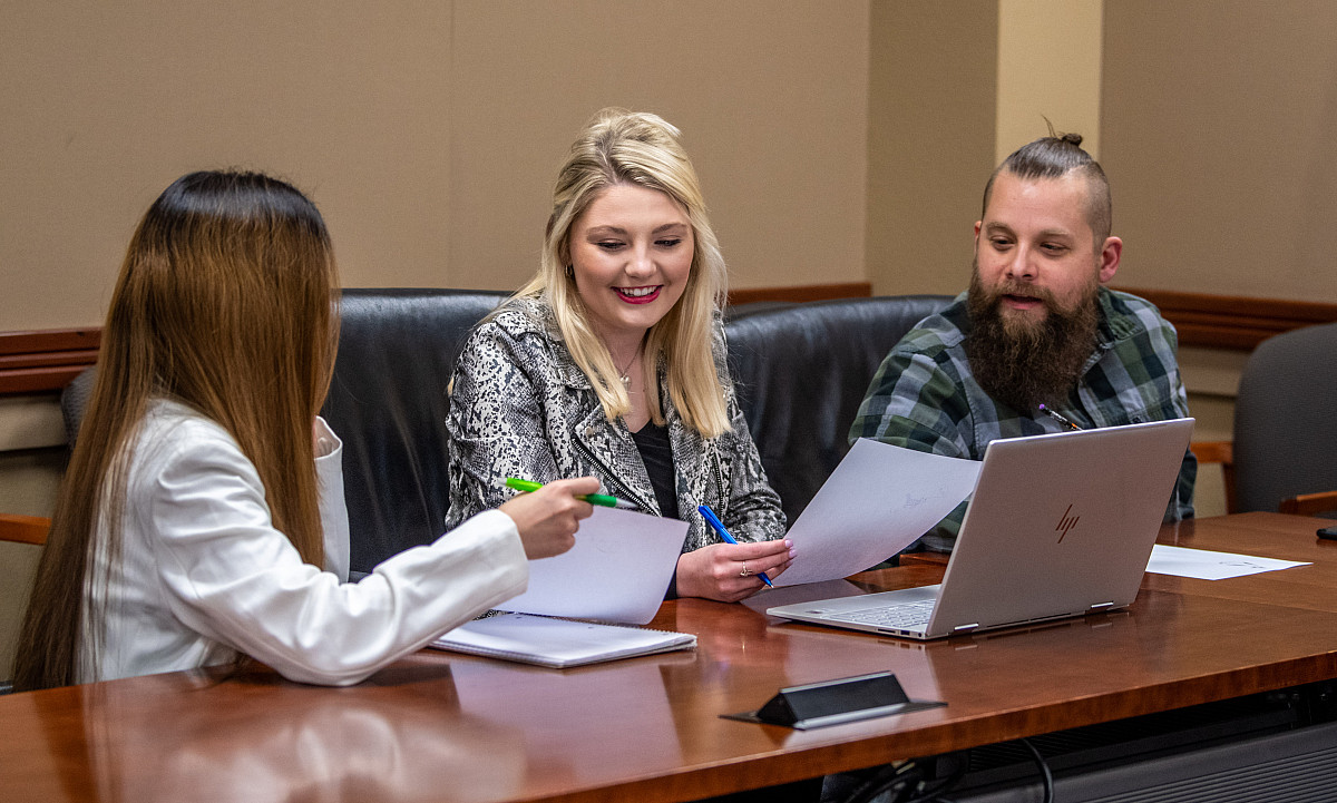 Students working together in a conference room
