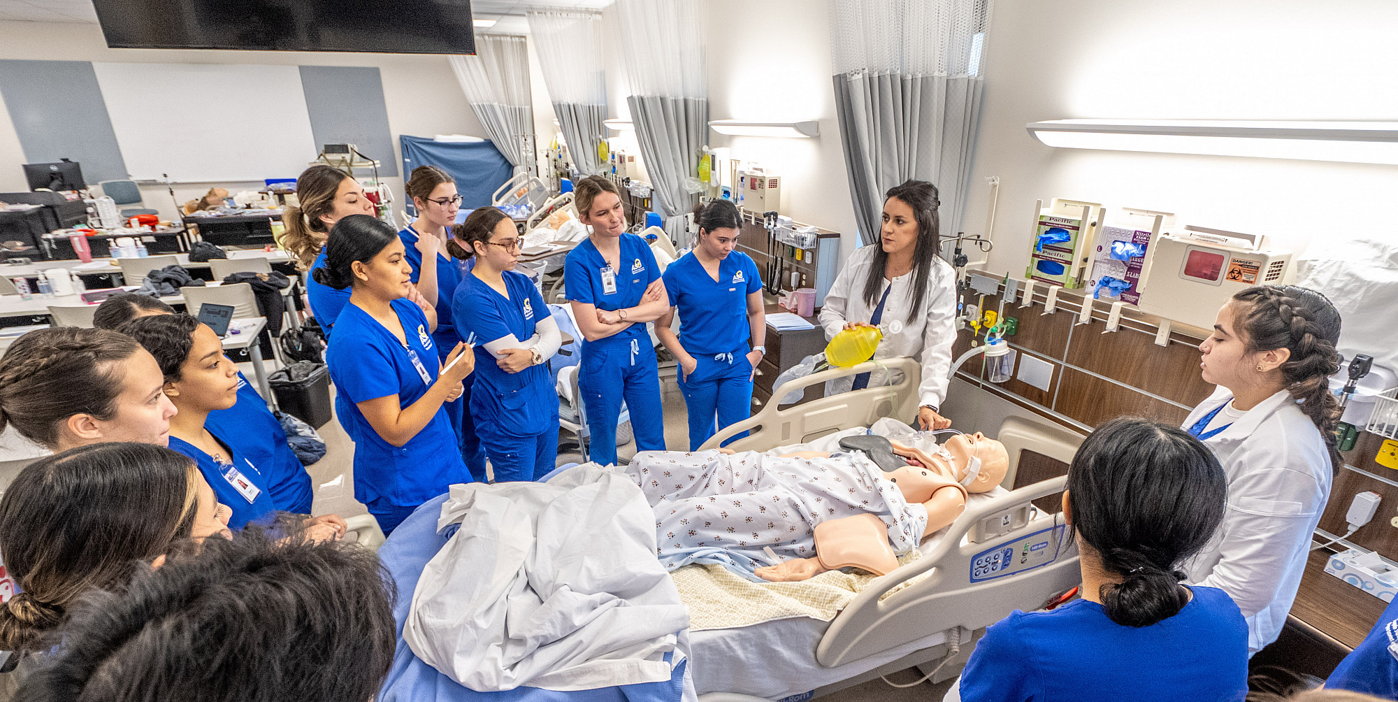ASU nursing professor teaching students with a practice mannequin.