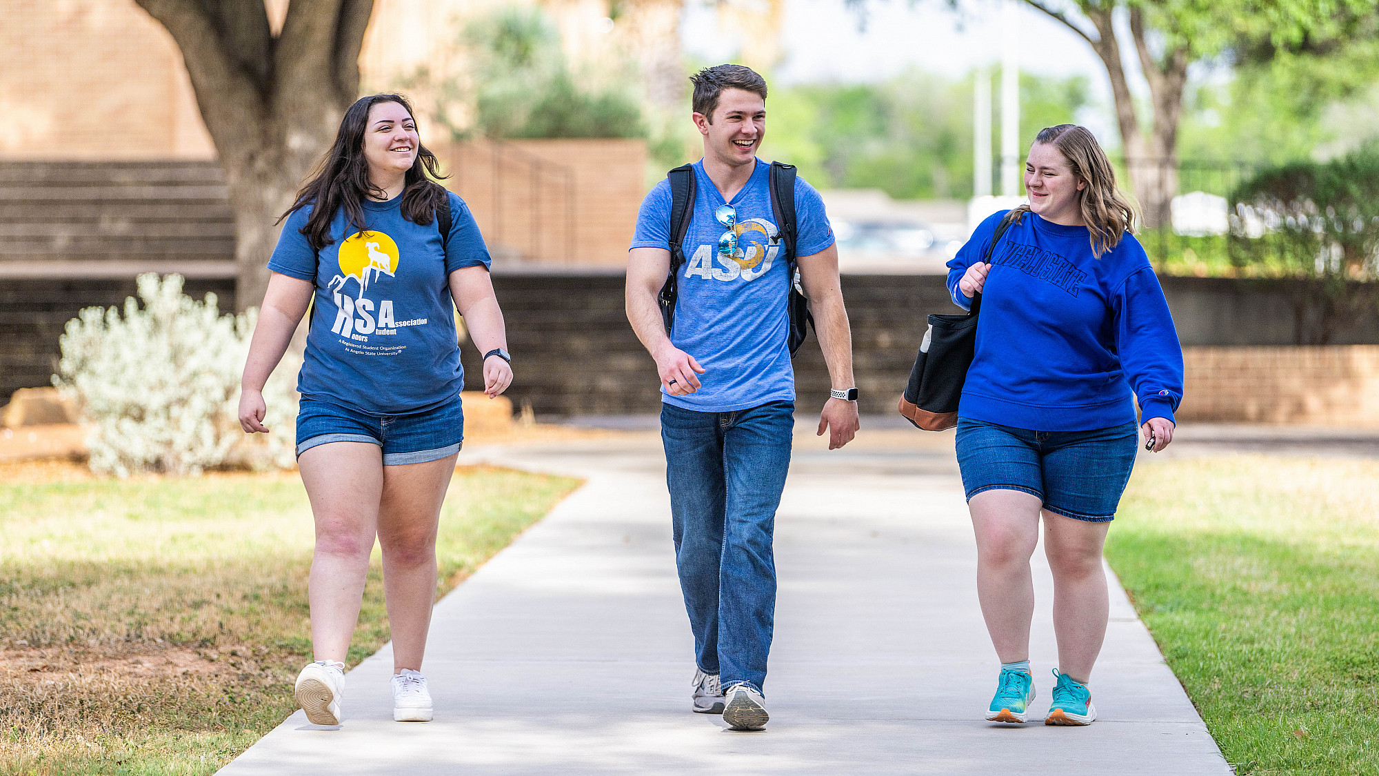 Three ASU Honors students walking and talking to each other.