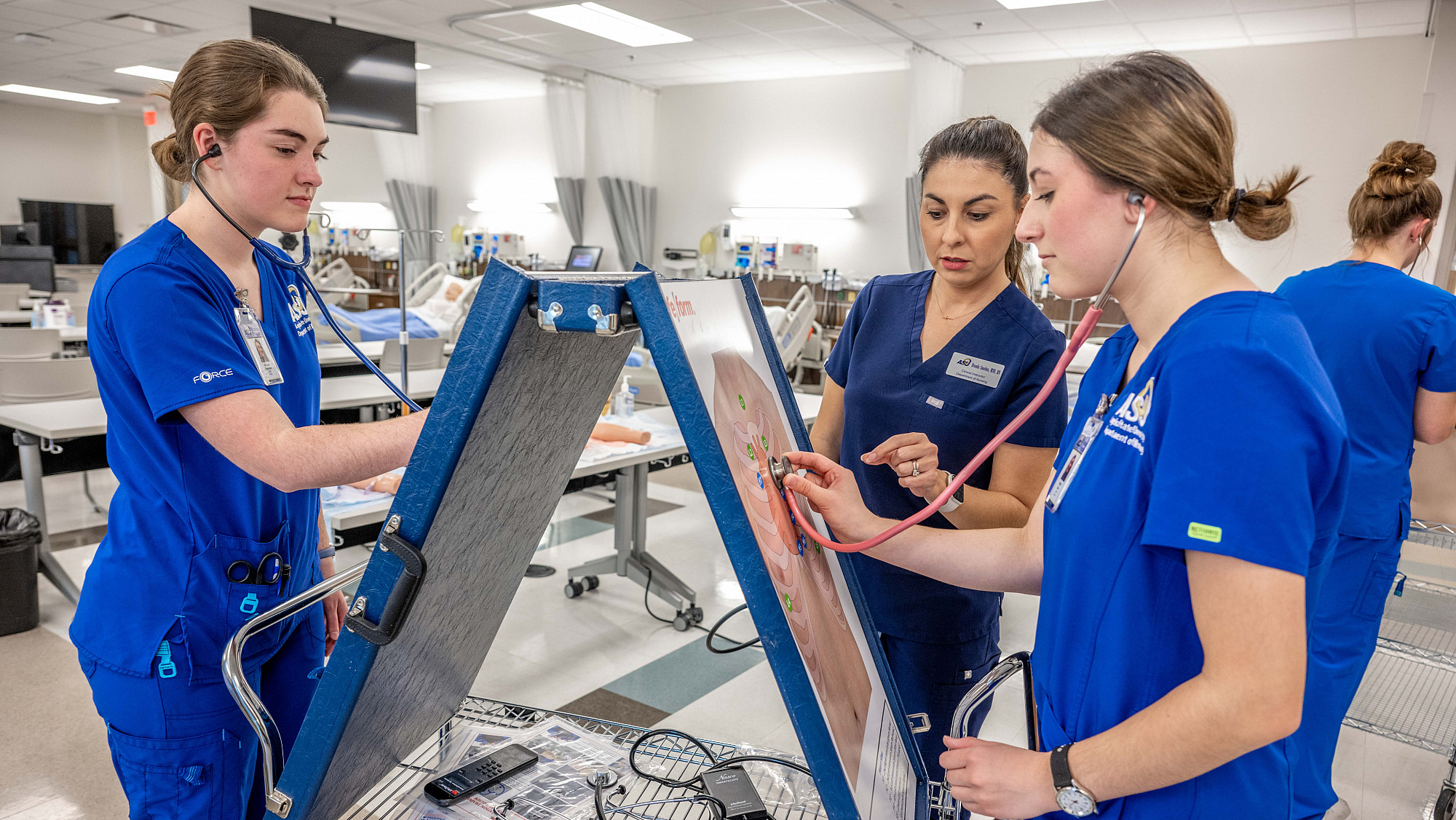ASU nursing professor teaching students with a practice diagram of the lungs.