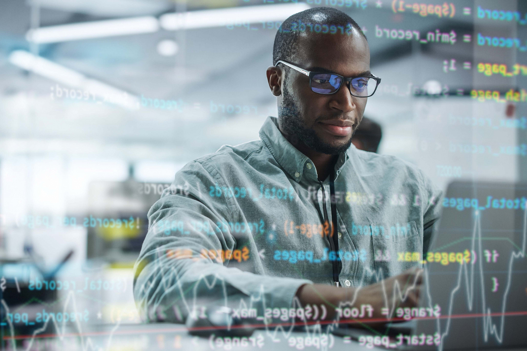 Portrait of an IT Programmer Working on Laptop Computer.