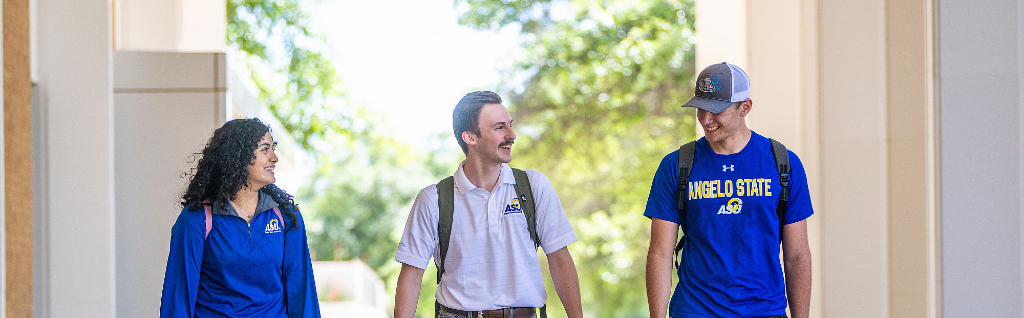 Three ASU honors students walking and talking in front of the Porter Henderson Library.