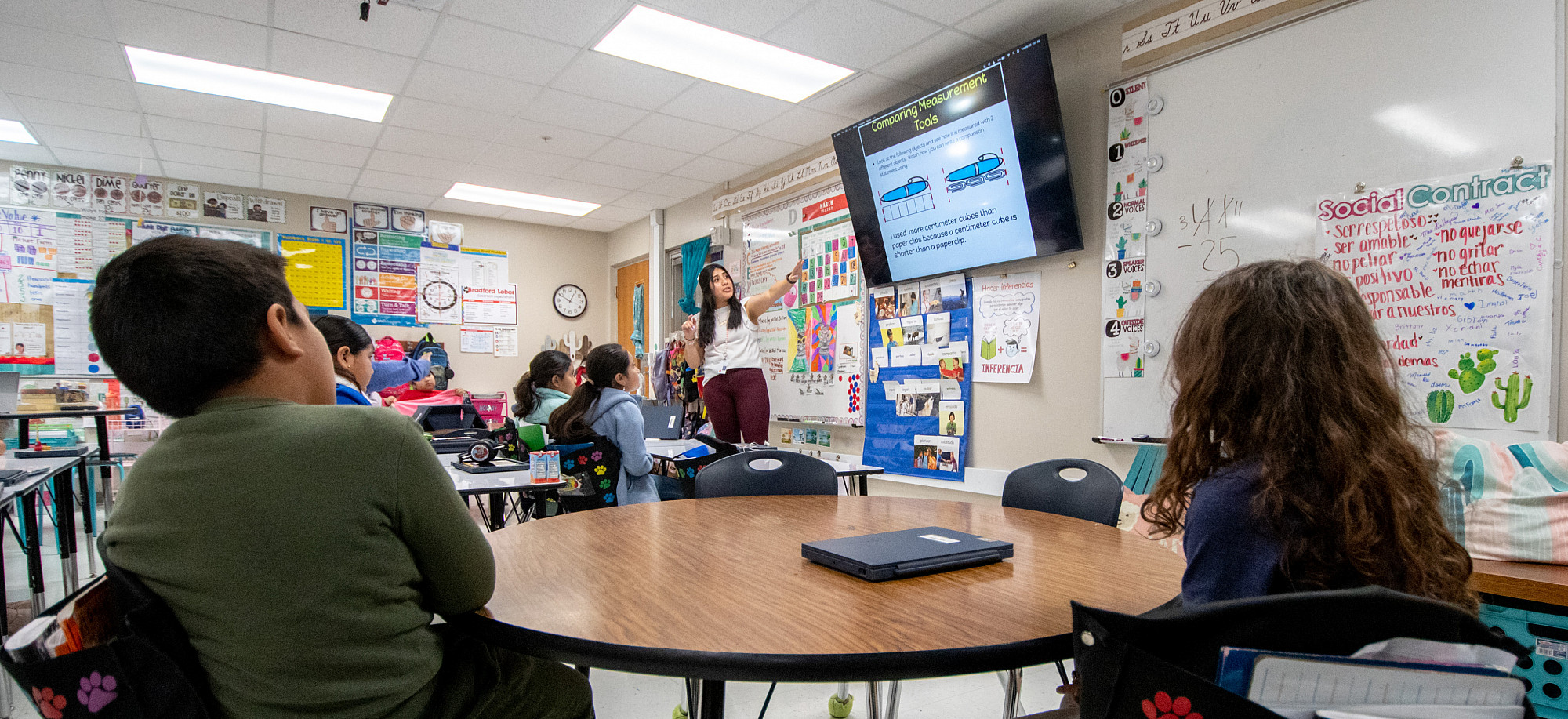 A student teacher working with children in a classroom