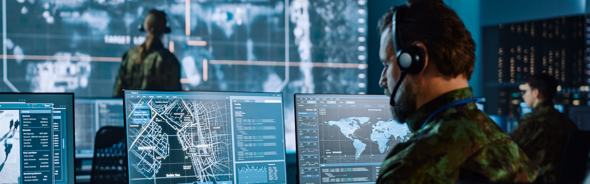 A military officer using a computer in a control room