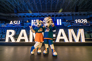 Roscoe and Bella, ASU mascots, in front of event signs that spell ASU, 1928, Ram Fam