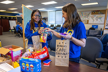 Two ASU honors students preparing for volunteer work in the honors lounge.
