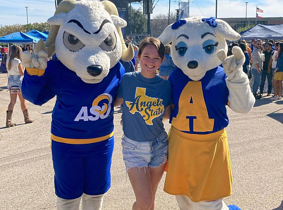 A student posing with Dominic and Bella at Ram Jam