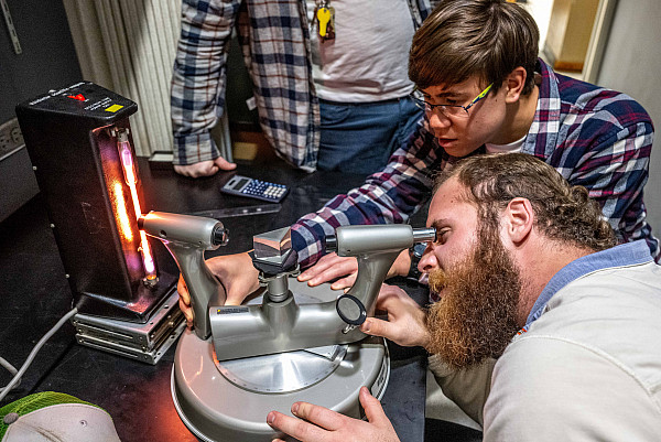 ASU Physics students using equipment in a lab.