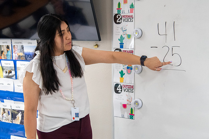 A student teacher working with children in a classroom