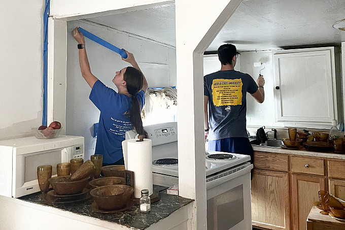 ASU Honors program students volunteering to repaint a house.