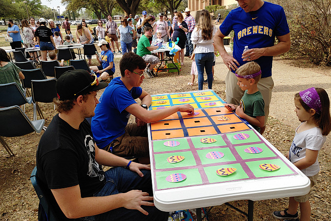 Two ASU Honors students hosting an Easter bingo.