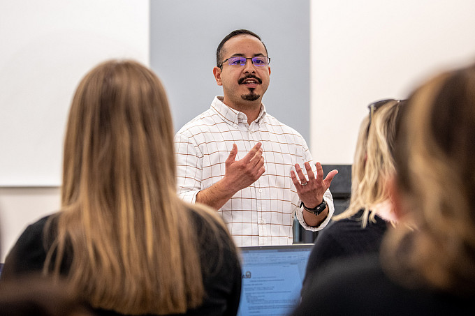 A professor teaching to a group of students in a class