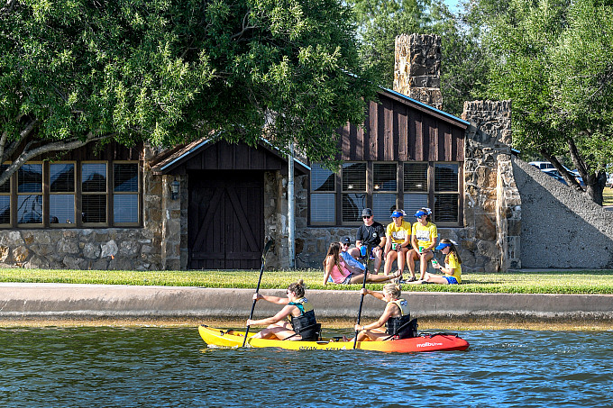 Students sitting outside the lake house