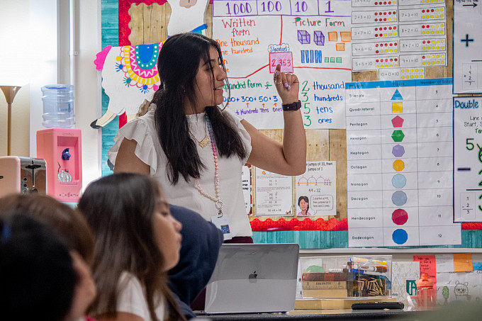 A student teacher working with children in a classroom