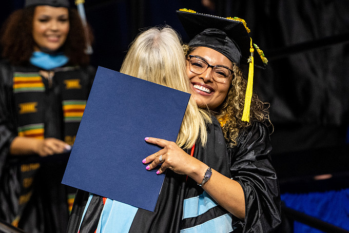An ASU graduate hugging a professor during the College of Education graduation