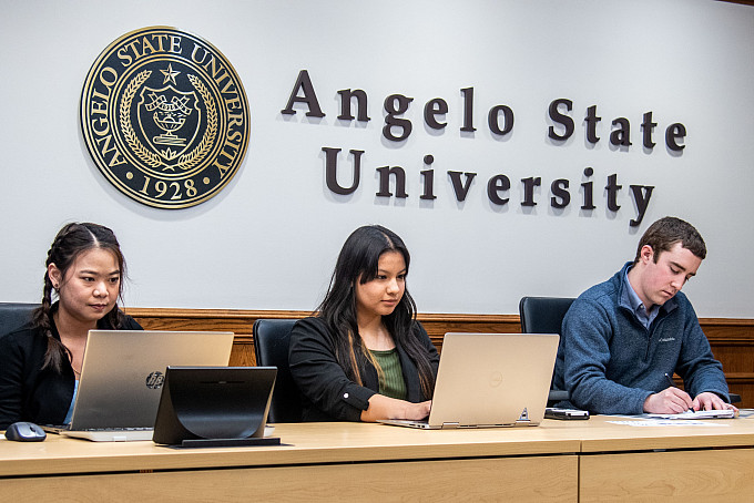 Students working in a conference room
