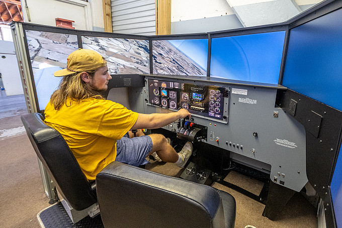ASU commercial aviation student practicing flying a plane through a simulation.