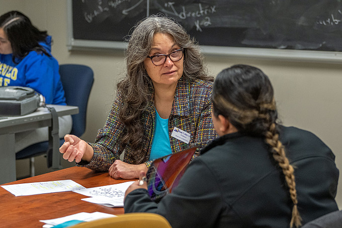 Angelo State Mathematics professor helping a student on a homework problem.