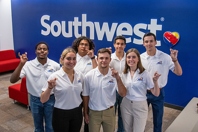 Students posing for a group photo while touring the South West Airlines facilities.