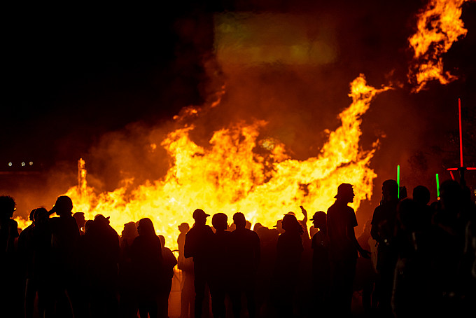 Angelo State students watching the ASU homecoming bonfire