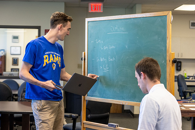 Two ASU Honors students working on their homework in the honors lounge.