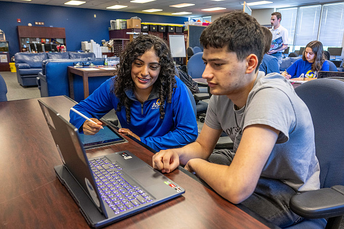 Two ASU honors students working on their homework in the honors lounge.