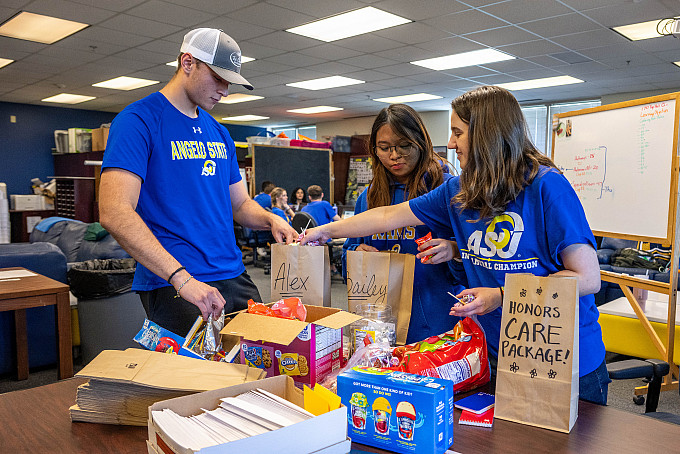Three ASU honors students preparing for volunteer work in the honors lounge.