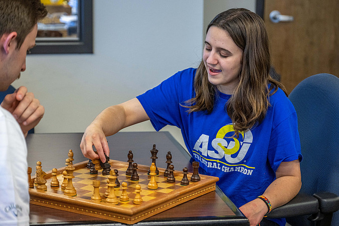 Two ASU honors students playing chess in the honors lounge.