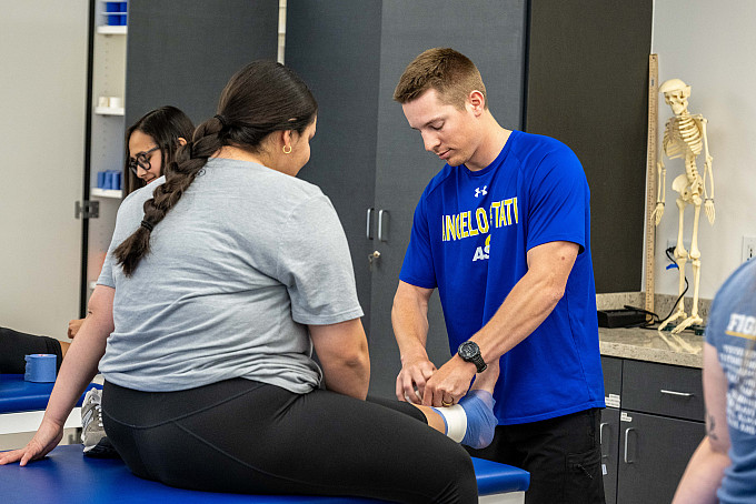 ASU Health Science Professions students practicing wrapping an injured foot in bandages.