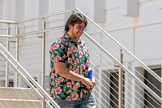 A student walking out of the Academic Building.