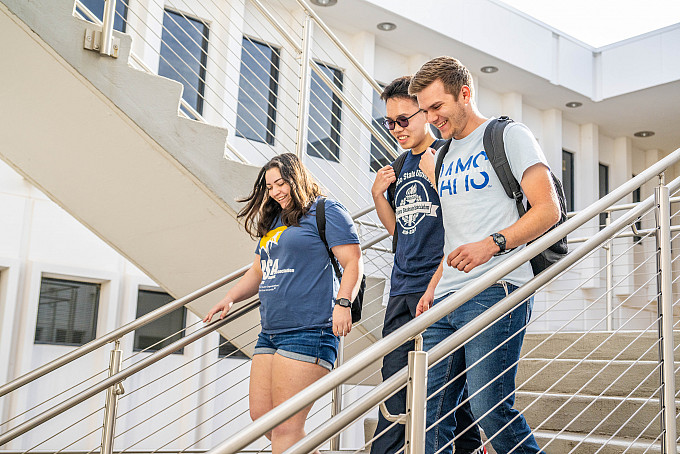 Three ASU Honors students walking out of the Academic Building.