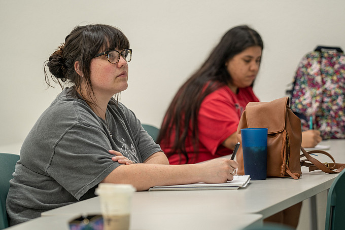 Psychology 02724 Student listening and taking notes during class.