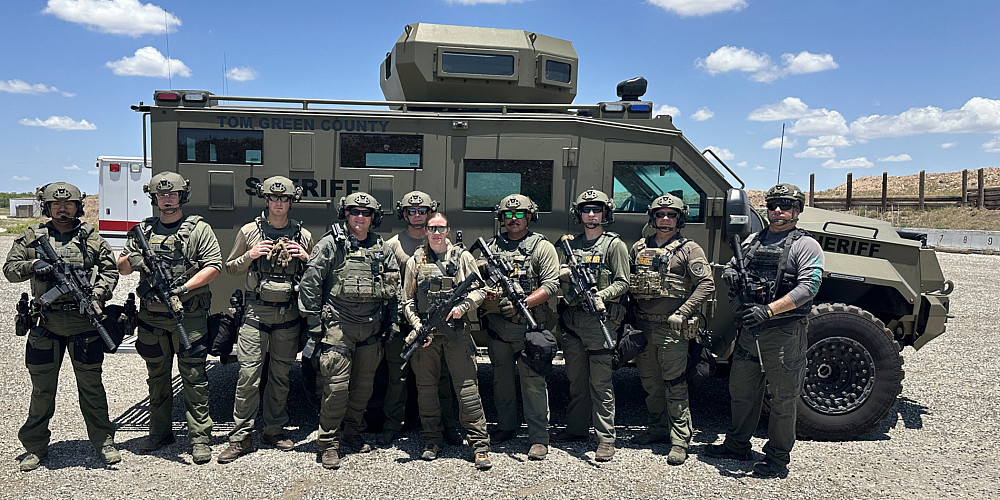 Angelo State alumna Senora Scott with the Tom Green County Sheriff's Department Special Response Team in front of their tactical vehicle