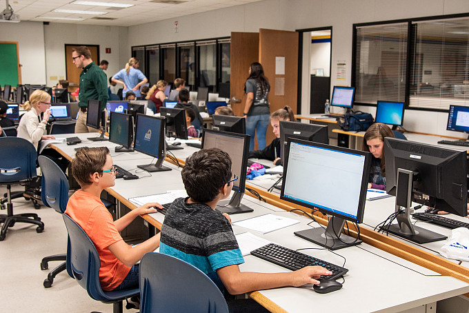 Students sitting at computers in a classroom.